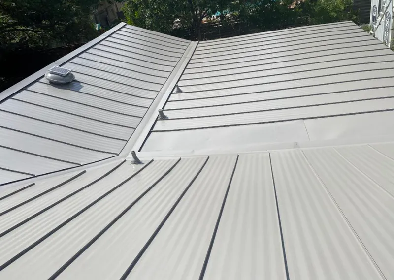 Solar attic fan installed on a metal roof for Roof Ventilation in Minnetrista